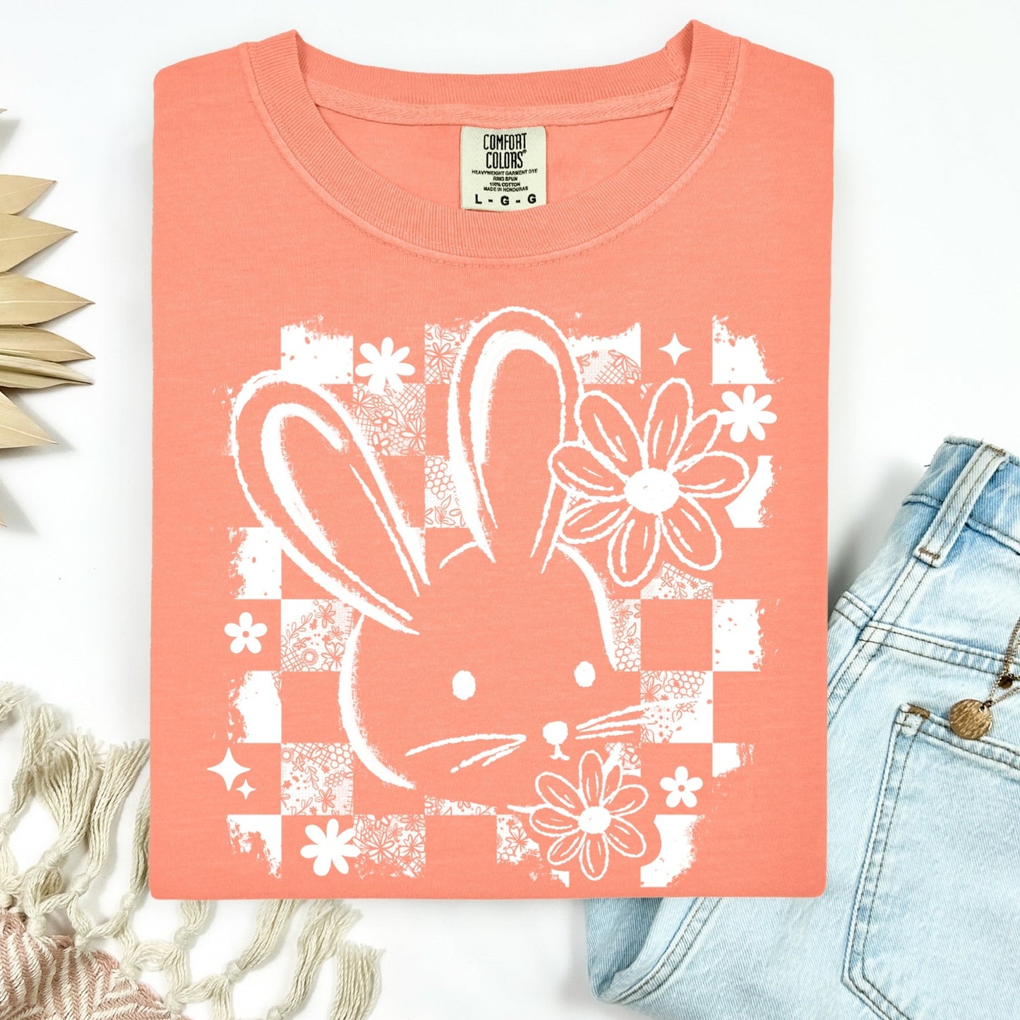 Coral t-shirt with white bunny and floral design on a white background
