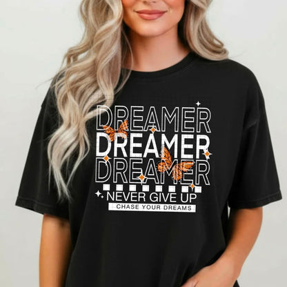 Person wearing a black t-shirt with motivational text and designs.