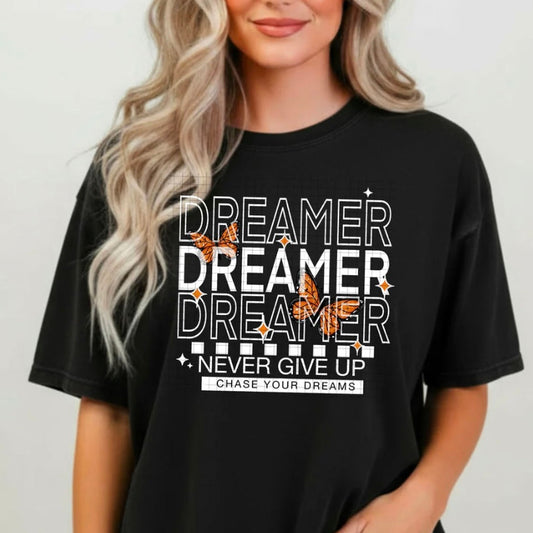 Person wearing a black t-shirt with motivational text and designs.