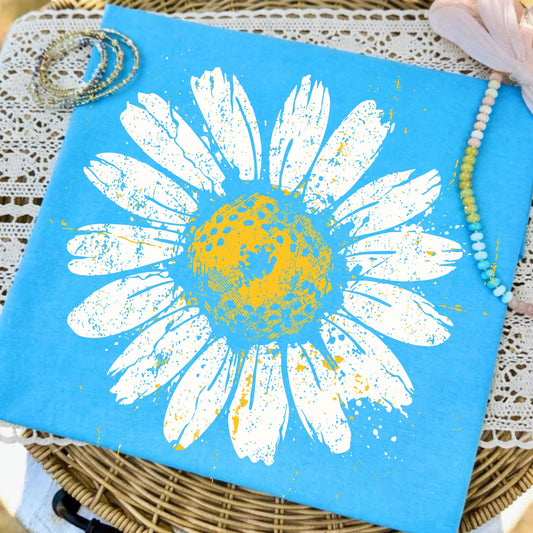 Blue paper with a white daisy design on a textured surface