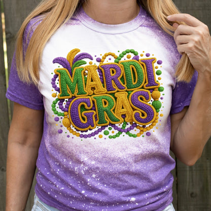 Person wearing a purple and white Mardi Gras-themed t-shirt with colorful text.