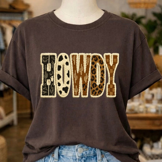 Brown t-shirt with 'HOWDY' print on a mannequin in a store setting