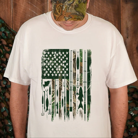 Person wearing a white t-shirt with a graphic design and a camouflage cap, standing against a wooden background.