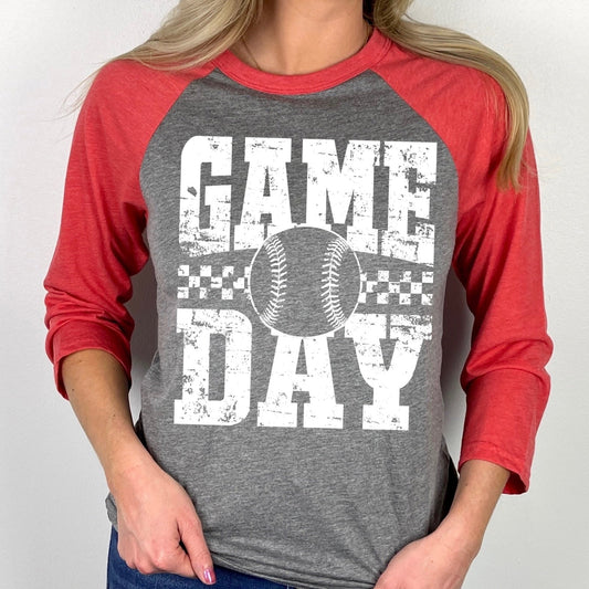 Person wearing a red and gray 'Game Day' baseball-style shirt with a baseball graphic.