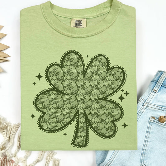 Green t-shirt with a black shamrock design on a white background