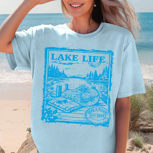Woman wearing a light blue 'Lake Life' t-shirt on a beach