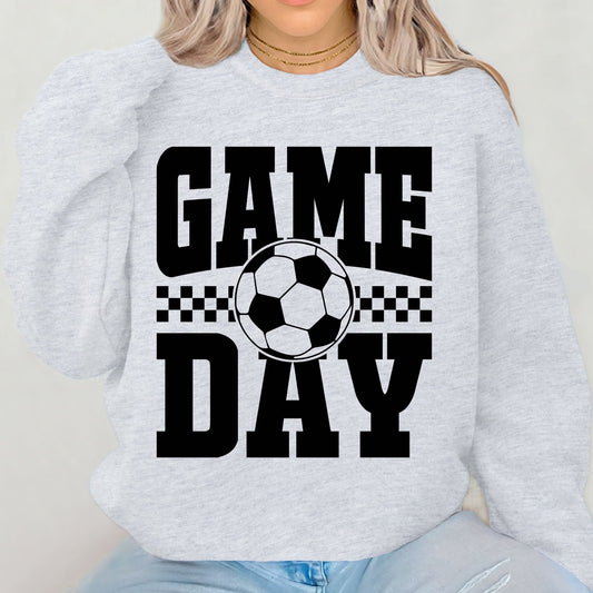 Person wearing a light gray sweatshirt with 'GAME DAY' and a soccer ball graphic.