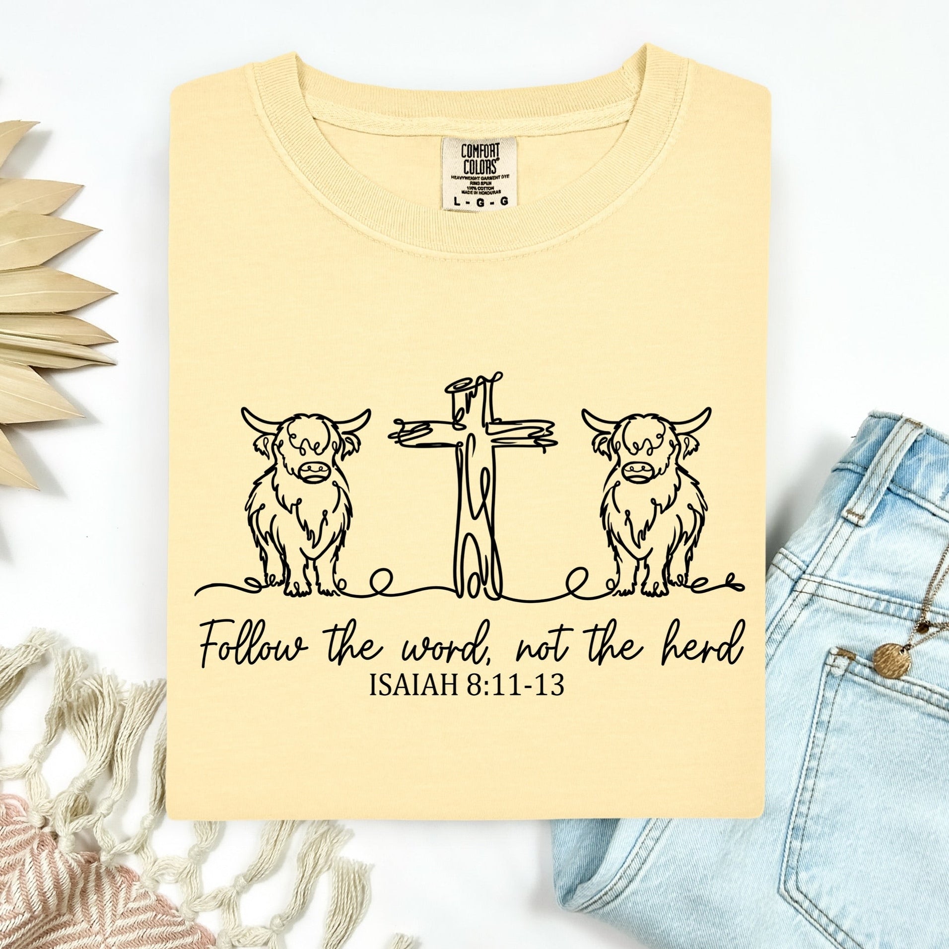 Yellow t-shirt with a graphic design and text on a white background