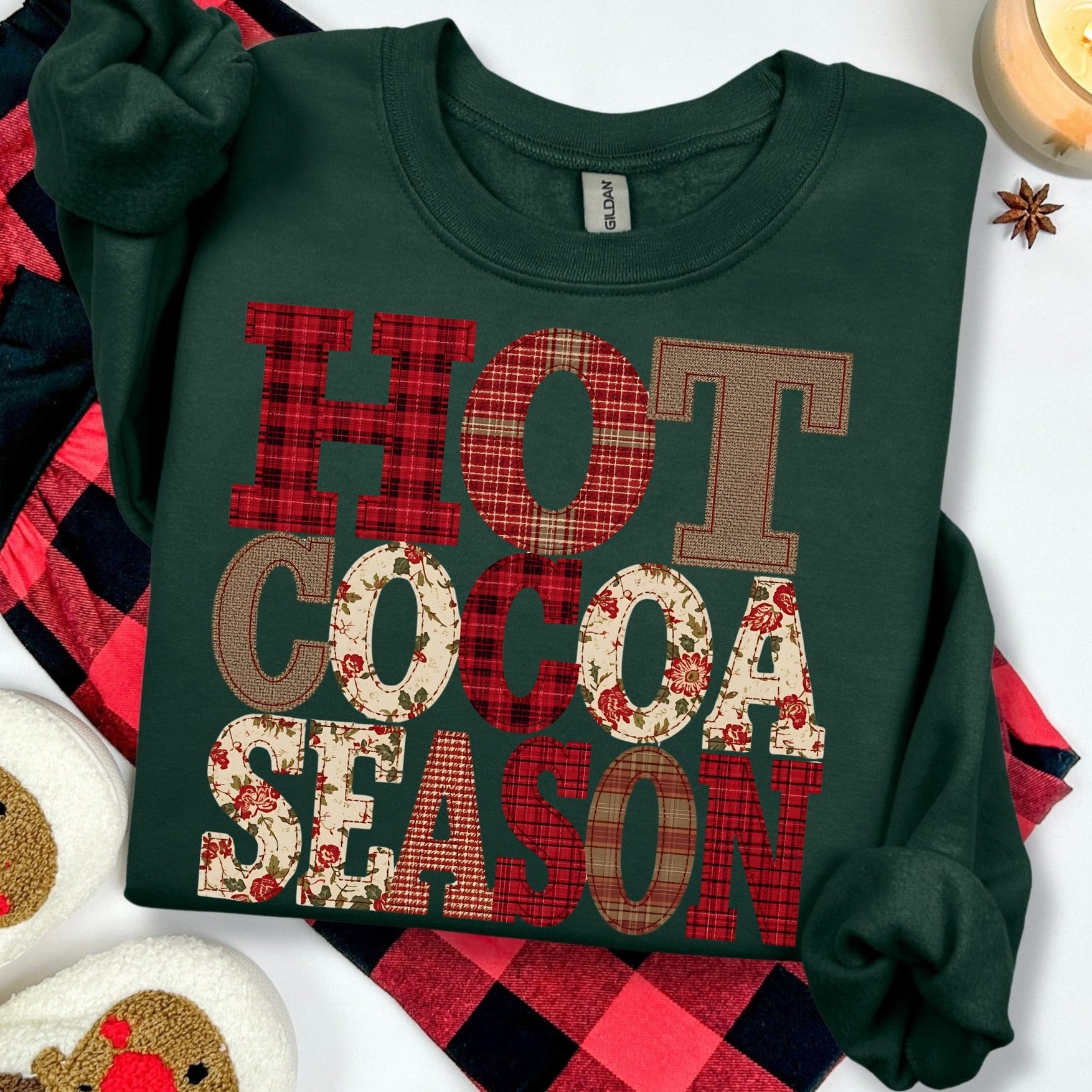 Green sweatshirt with 'Hot Cocoa Season' text on a white background