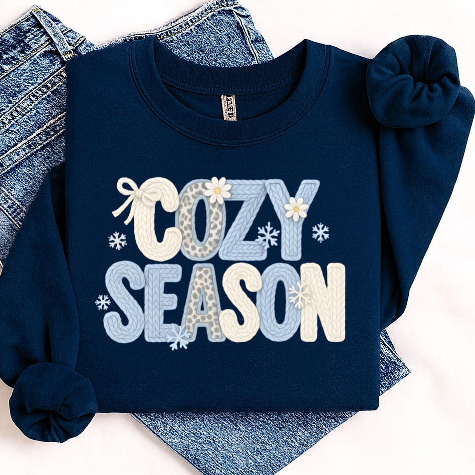 Navy blue sweatshirt with 'Cozy Season' text on a white background