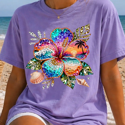 Woman wearing a purple t-shirt with a colorful butterfly design on a beach.