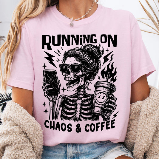 Person wearing a pink t-shirt with a skeleton graphic and text 'Running on Chaos & Coffee'.